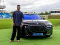 Vinícius Jr. posa junto a un BMW eléctrico en Madrid, disfrutando de las ventajas de un coche eléctrico en la ciudad.