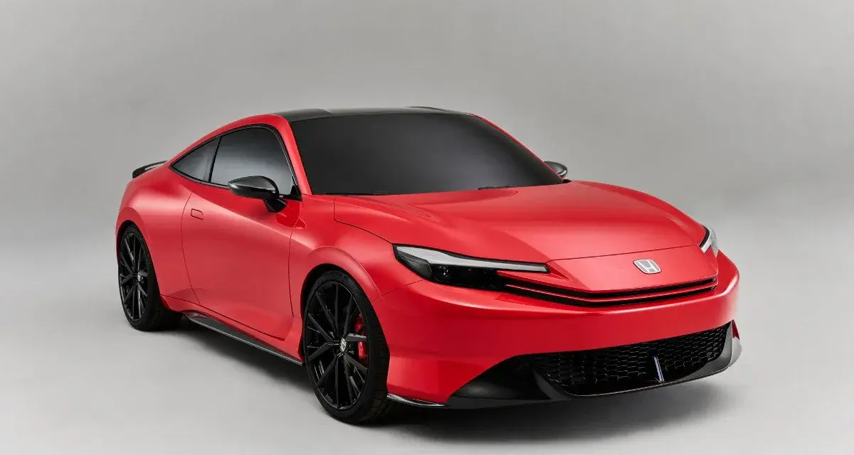 Coche deportivo rojo con techo negro, llantas negras y pinzas rojas. Los coches híbridos son automáticos, ofreciendo una conducción suave y eficiente.