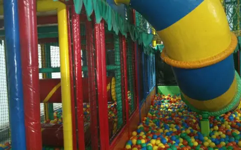 Parque infantil en Gijón con niños, perfecto para un día de lluvia. ¡A disfrutar de las bolas de colores!