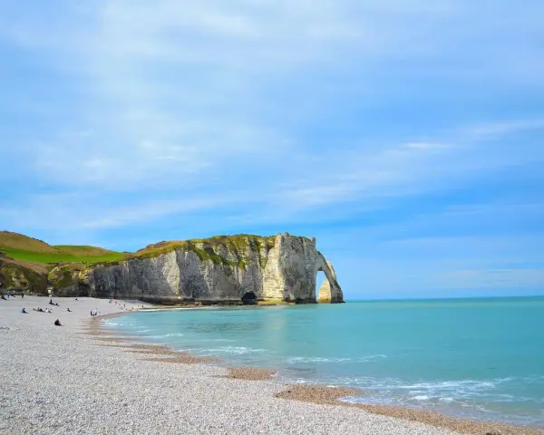 Acantilados impresionantes y playa de guijarros en Étretat, un lugar imperdible que ver en Normandía.