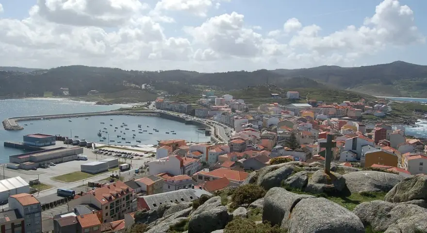 Vista panorámica de Muxía, con su puerto y casas de tejados rojos. Un lugar perfecto para comer y disfrutar del paisaje.